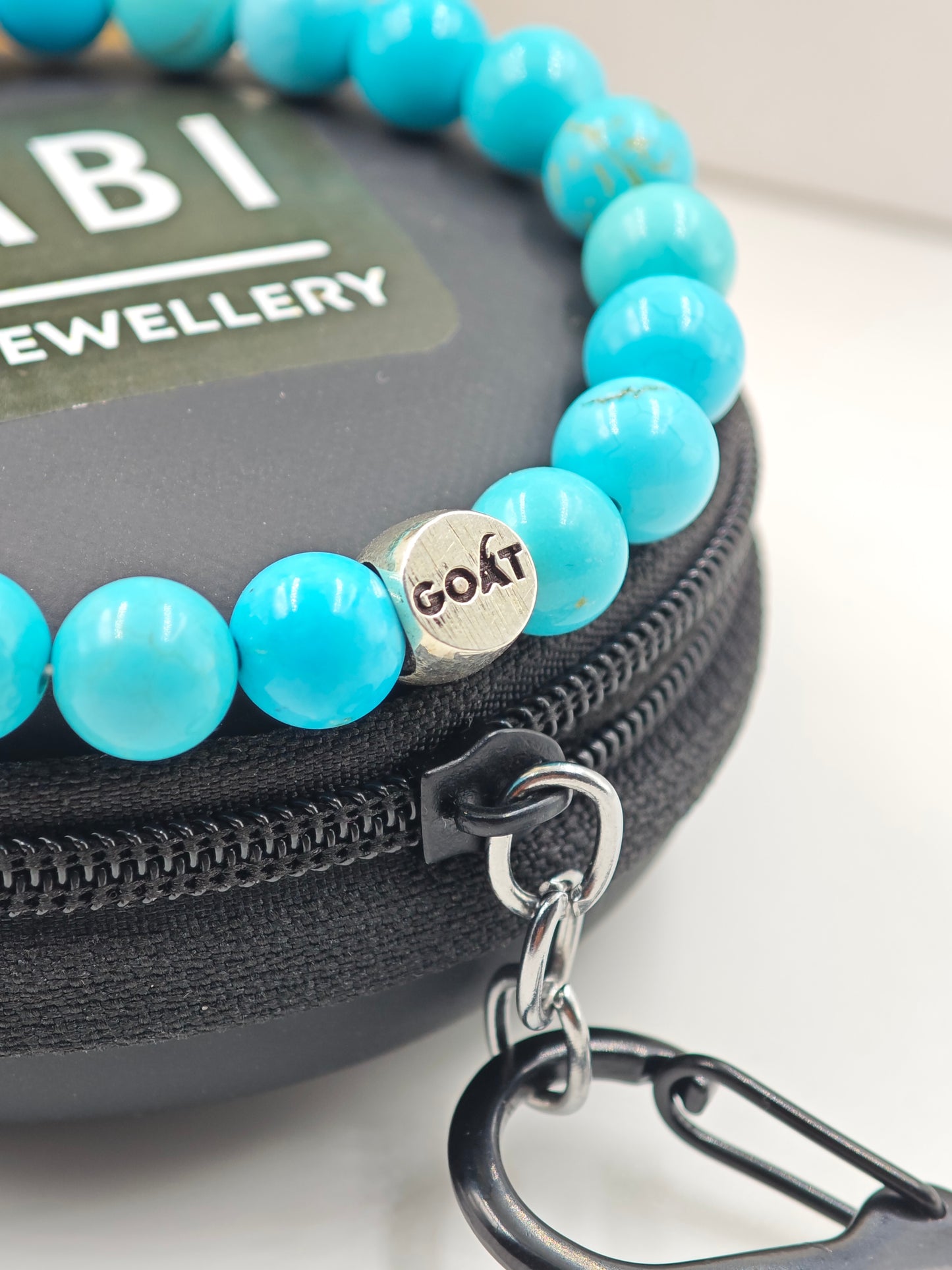 TURQUOISE STONE BEADED BAND WITH SILVER G.O.A.T SIGNATURE ROAUND DRUM CLASP